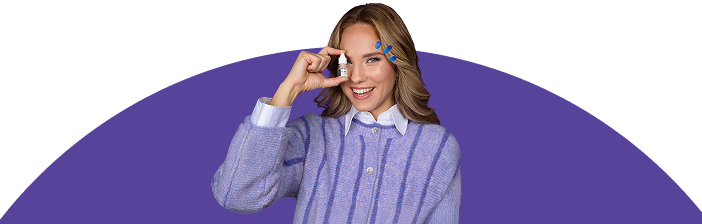 Woman in purple holding eye drops