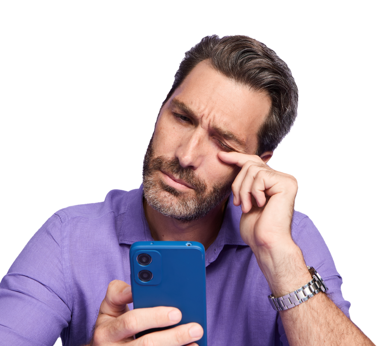 Man looking at his phone scratching his eye